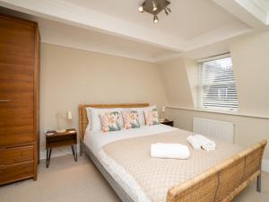 a bedroom with a bed with a dresser and a window at Pass the Keys Spacious 3 bed apartment in prime central location in Bath