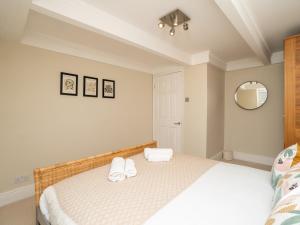 a bedroom with a bed with two towels on it at Pass the Keys Spacious 3 bed apartment in prime central location in Bath