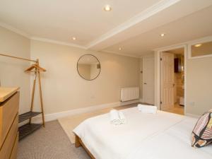 a bedroom with a large white bed and a mirror at Pass the Keys Spacious 3 bed apartment in prime central location in Bath
