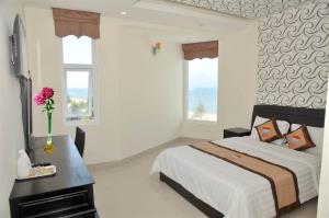 a bedroom with a large bed and two windows at Central Ly Son in Ly Son +42 photos