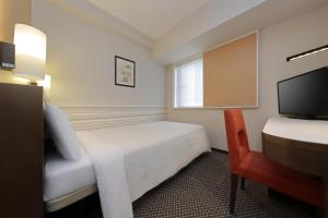 Postel nebo postele na pokoji v ubytování Keio Presso Inn Shinjuku