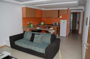 a living room with a couch and a kitchen at Apartamento Rita in Praia