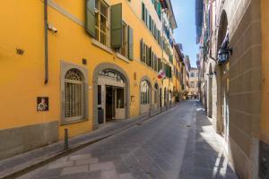 an empty street in a city with yellow buildings at Hotel Art Atelier in Florence