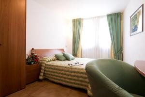 Schlafzimmer mit einem Bett und einem Fenster in der Unterkunft Residence Campo Smith in Bardonecchia