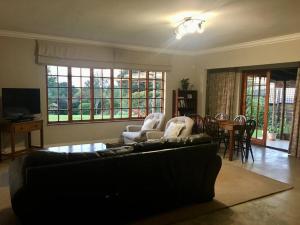 a living room with a couch and chairs and a table at Number 10 in Nottingham Road