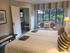 a bedroom with two beds and a chair and a window at Number 10 in Nottingham Road