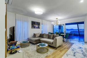 a living room with a couch and a table at Luxury penthouse Marina - Sukošan in Sukošan
