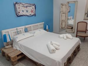 a bedroom with a large bed with towels on it at Villa Il Lupo in Pachino