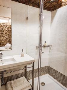 a bathroom with a sink and a shower at Casa da Sé Cathedral Suites in Coimbra