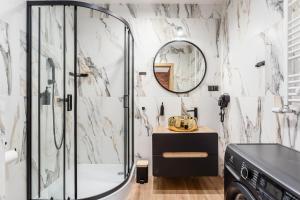 a bathroom with a shower and a mirror at Rent like home - Dwie Motławy in Gdańsk