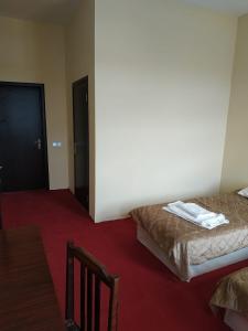 a bedroom with two beds and a door to a room at Hostel One in Lankaran