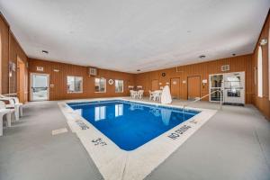 a large swimming pool in a large room with a house at Quality Inn in Hastings