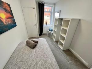 a bedroom with a bed with a pillow on the floor at Apartments @52 in Bridlington