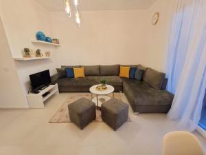 a living room with a couch and a table at Valamar ED Apartment in Hamallë