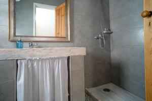a bathroom with a shower and a sink and a mirror at Kochab Sintra by LovelyStay in Sintra
