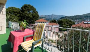 a table and two chairs on a balcony with a view at Guest House Mrdalo in Dubrovnik