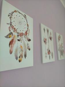 two framed pictures of flowers on a wall at Suite Paradiso in Castelnuovo Magra