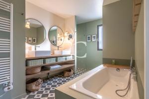 a bathroom with a tub and two mirrors at Easy Clés-Luxury Villa 16p breathtaking view in Guéthary