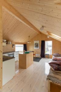 a kitchen and living room in a wooden house at Villa Lofoten - Fisherman's cabin in Kvalnes