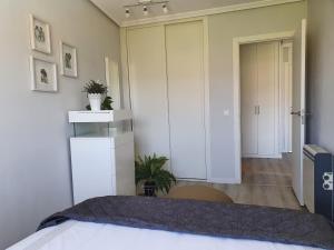 a bedroom with a bed and a door to a hallway at Apartamento con piscina en Boiro - Cabo de Cruz in Boiro +24 photos