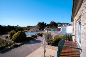 a house with a wooden staircase next to a pool at Kochab Sintra by LovelyStay in Sintra