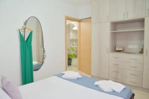 a bedroom with two beds and a mirror at Alkyonis Apartment Milos in Triovasálos +6 photos