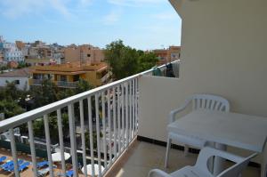 a balcony with a table and a view of a city at Linda in Can Pastilla