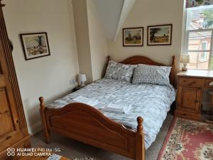 a bedroom with a large bed with a wooden frame at Lincoln House in Bournemouth