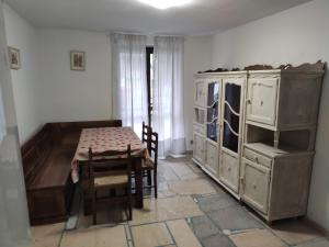 a room with a table and a dining room at Appartamento nel verde a Gravere in Gravere +19 photos