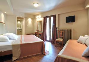 Postel nebo postele na pokoji v ubytování Kentrikon Hotel