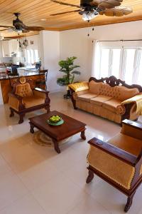 a large living room with couches and a table at Redknot Manor Guest house/Hotel in Matthew Town