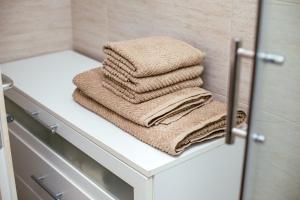 a pile of towels sitting on a shelf in a bathroom at M&M Apartments in Biograd na Moru