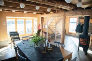 a dining room with a table and a fireplace at The Saltery in Kvalnes