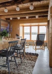 a dining room with chairs and a table and a table and chairsktop at Villa Lofoten - The Saltery in Kvalnes