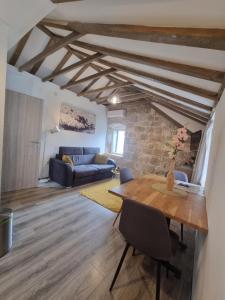 a living room with a table and a couch at Heritage Apartments Trumbić in Split