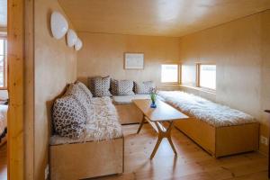 a room with a couch and a table in it at Villa Lofoten - The Saltery in Kvalnes