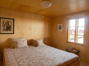 a bedroom with a large bed and a window at Villa Lofoten - The Saltery in Kvalnes +30 photos