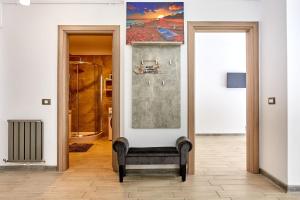 a chair in a hallway with a painting on the wall at Apartament Iris by Alz in Năvodari +50 photos