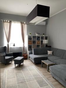 a living room with a couch and a table at Régimódi Apartman in Siófok