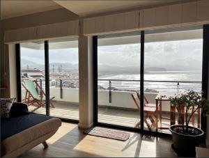 a living room with a view of the ocean at Azorean Sunset Loft in Ribeira Grande