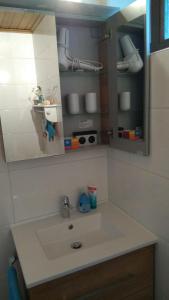 ein Bad mit einem Waschbecken und einem Spiegel in der Unterkunft Haus Flora am Kaiser in Niederndorf