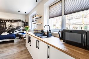 a kitchen with a sink and a counter top at Cinema Apartment in Zakopane