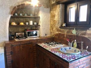 a kitchen with a stove and a counter top at Locanda Angelica in Giarratana