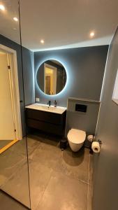 a bathroom with a toilet and a sink and a mirror at Villa Amalie in Egernsund