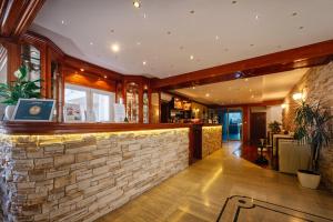 a bar in a restaurant with a stone wall at Apartman Lucija Međugorje in Međugorje