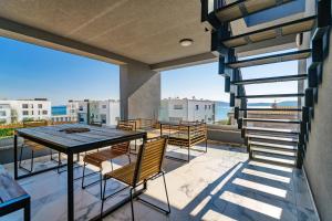a patio with a table and chairs on a balcony at Luxury penthouse Marina - Sukošan in Sukošan
