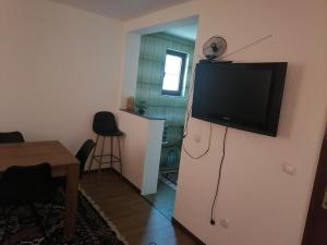 a living room with a television on a refrigerator at Zuta Kuca Sunca in Visoko