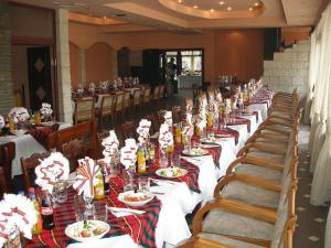 a long row of tables with plates of food on them at Hotel Grivitsa in Pleven +72 photos