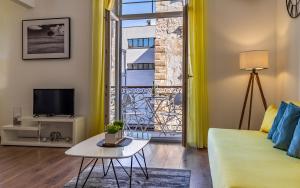a living room with a couch and a table and a window at Apartment Dream Pula - City Centre in Pula