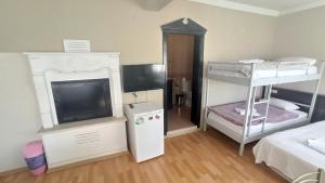 a room with two bunk beds and a flat screen tv at EPHESUS CENTRUM in Selcuk